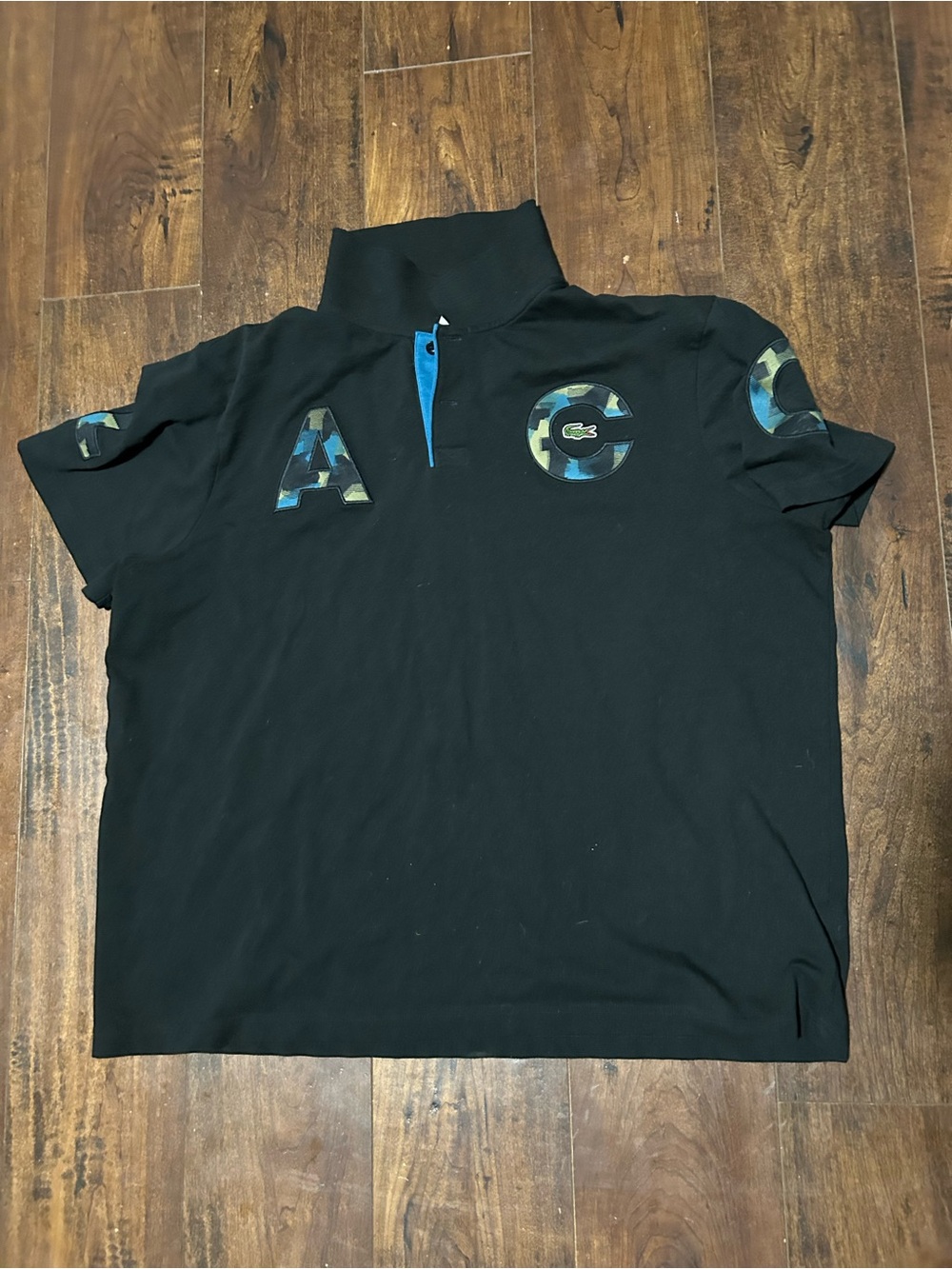 Lacoste Black Polo with Blue and Green Camo Lettering